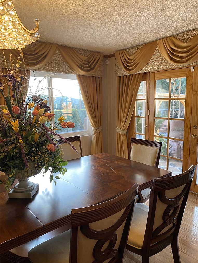 A luxurious dining room with a large chandelier and flower vase