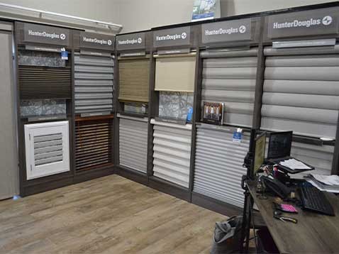 Store interior showcasing several different types of window coverings