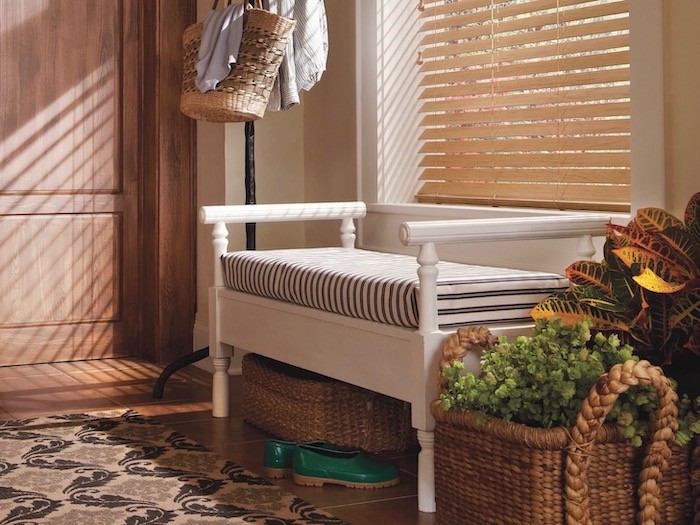 Bench seat with stripe cushion and wood blind in window